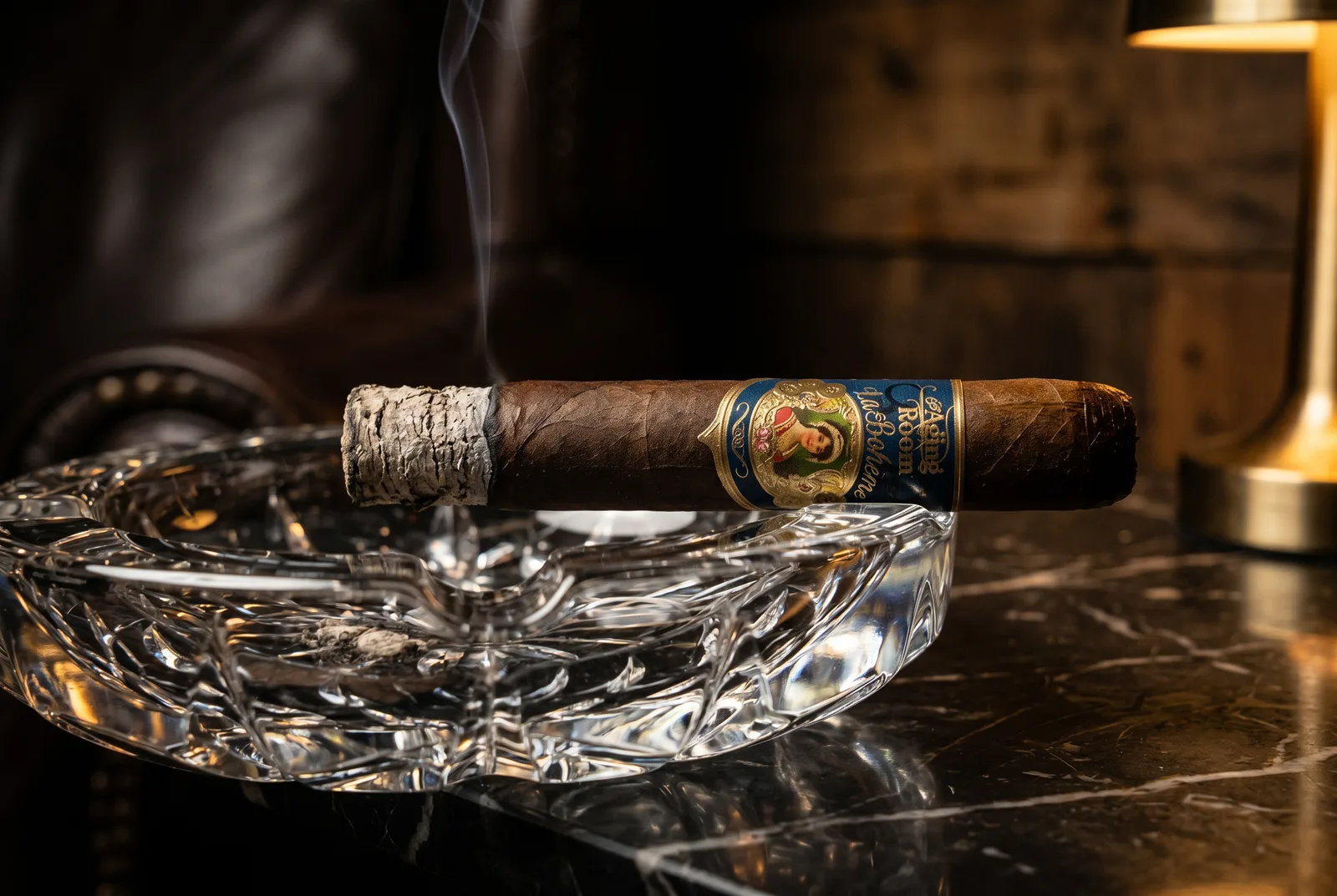 Aging Room La Boheme Poeta resting in a crystal cigar ashtray