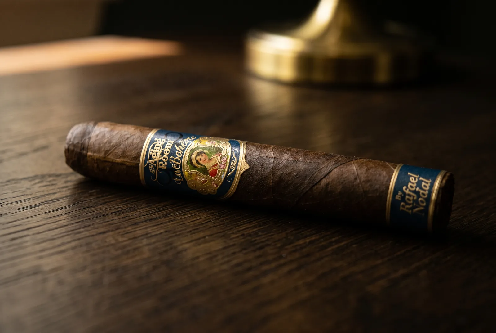 Aging Room La Boheme Poeta on a dark oak table showing wrapper texture