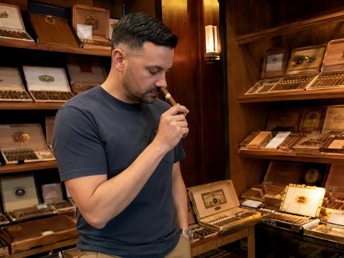 Man smelling a cigar correctly, held at a distance from the nose, gentle inhale at the foot
