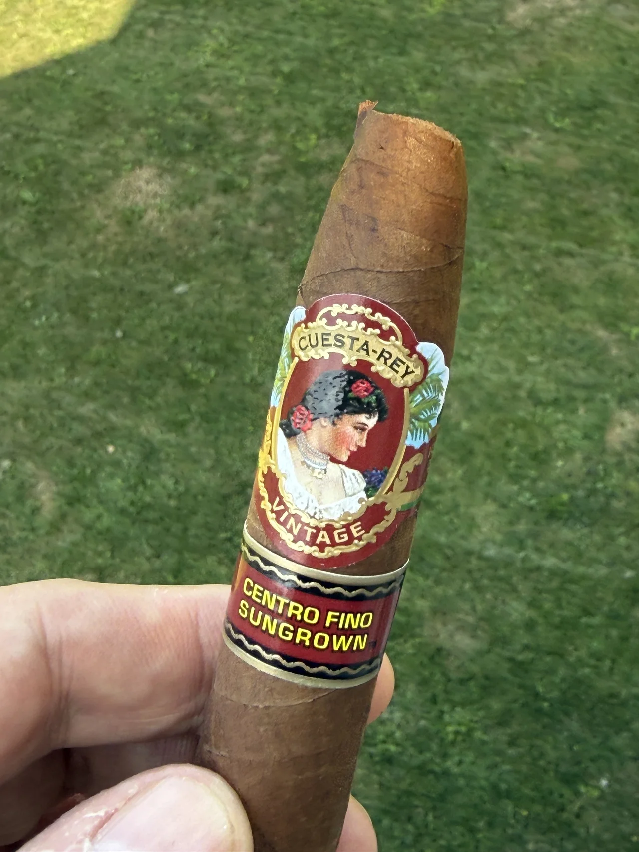 Norm Farrar holding the Cuesta-Rey Centro Fino Sungrown Pyramid No. 9 outdoors