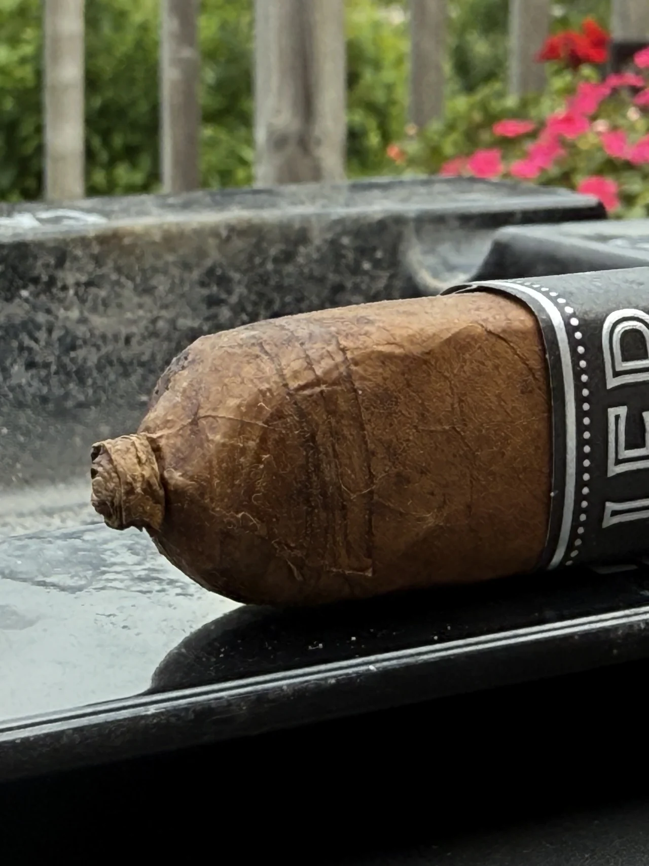 JFR 20th Anniversary Maduro Titan resting on an ashtray on Norm's porch