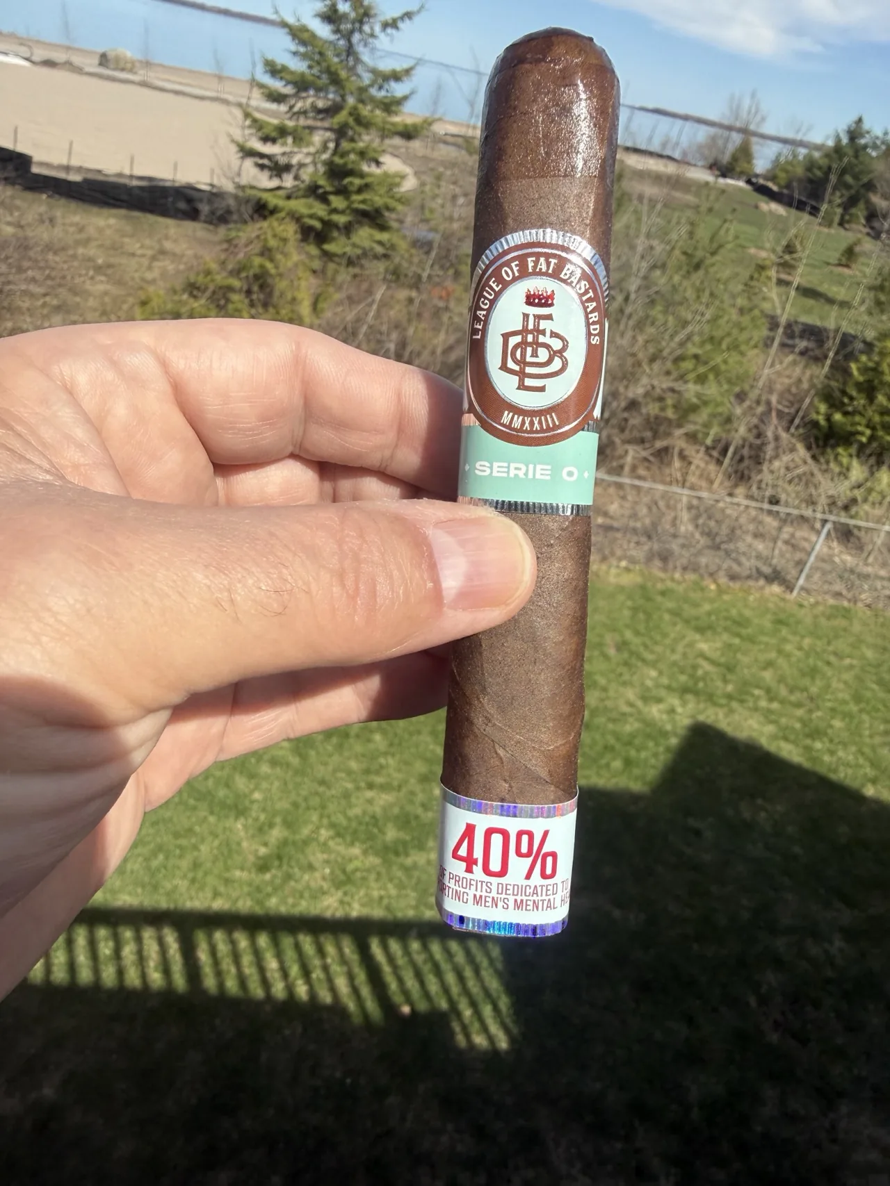 LEAGUE OF FAT BASTARDS SERIE O 6&times;60 BOX PRESS held up on the porch on a cold spring day, mint Serie O band in view
