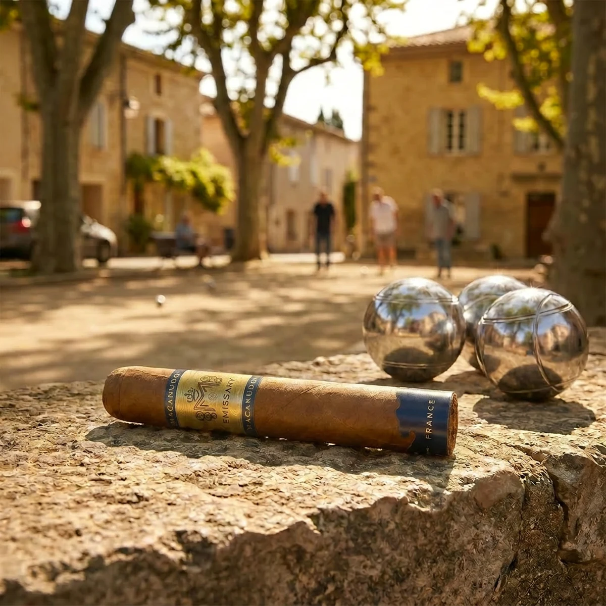 MACANUDO EMISSARY FRANCE ROBUSTO 5×52 on a stone ledge in a French petanque square