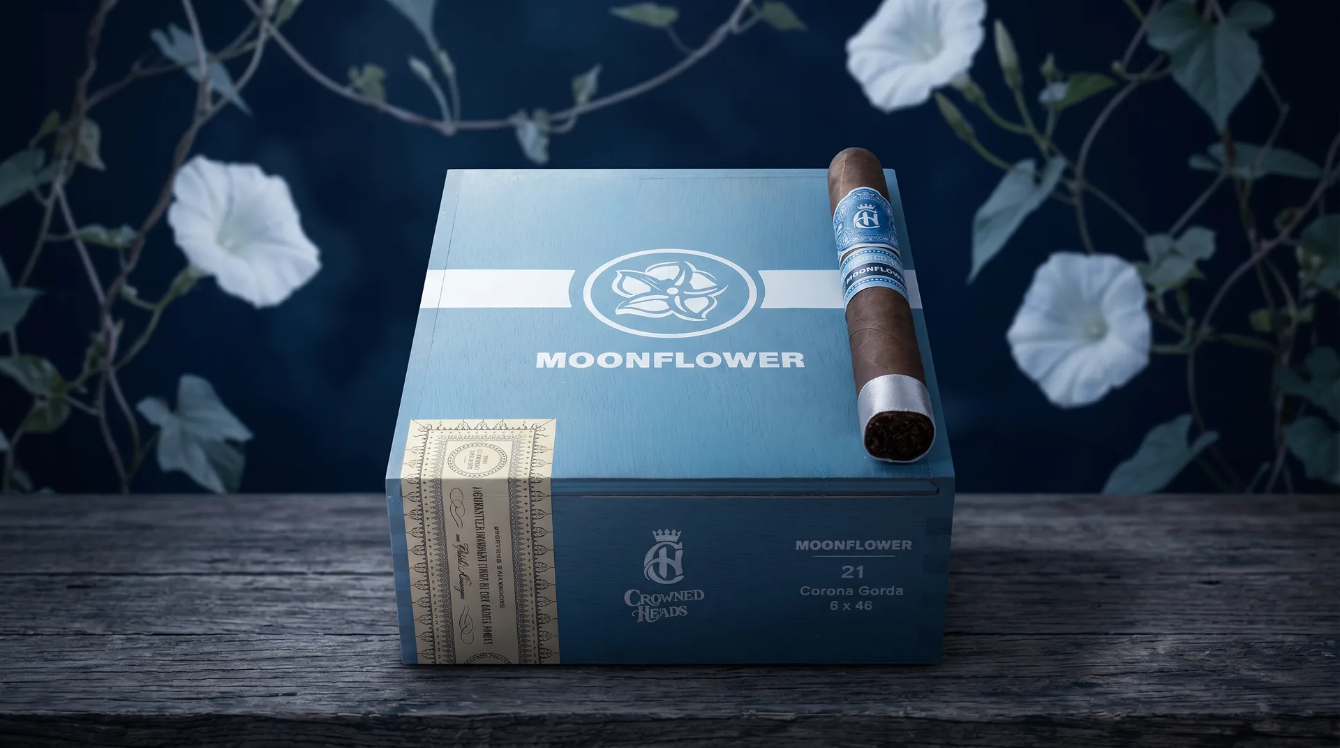 Crowned Heads Moonflower Corona Gorda box among white moonflowers at night