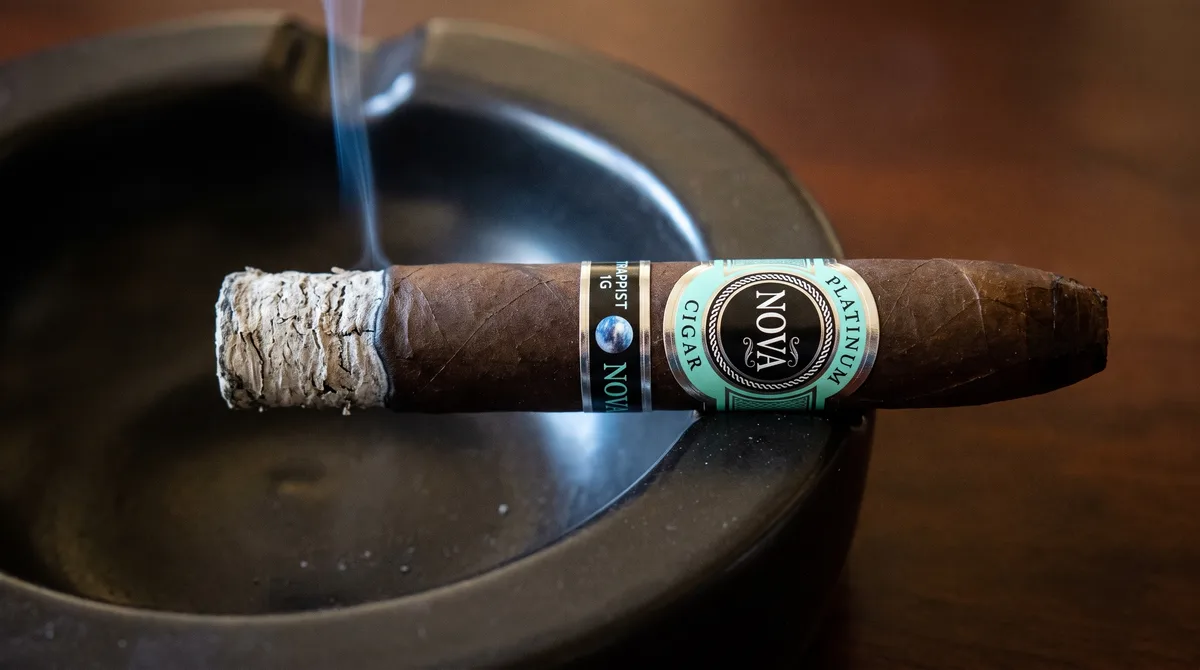 PLATINUM NOVA TRAPPIST 1G TORPEDO 7&frac14;&times;54 resting in a cigar ashtray