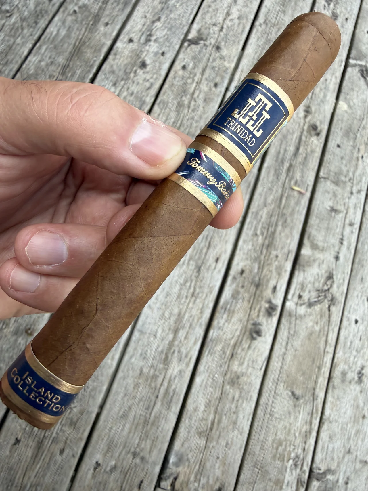 TRINIDAD X TOMMY BAHAMA ISLAND COLLECTION BREEZE TORO 6×54 held in hand on the porch deck